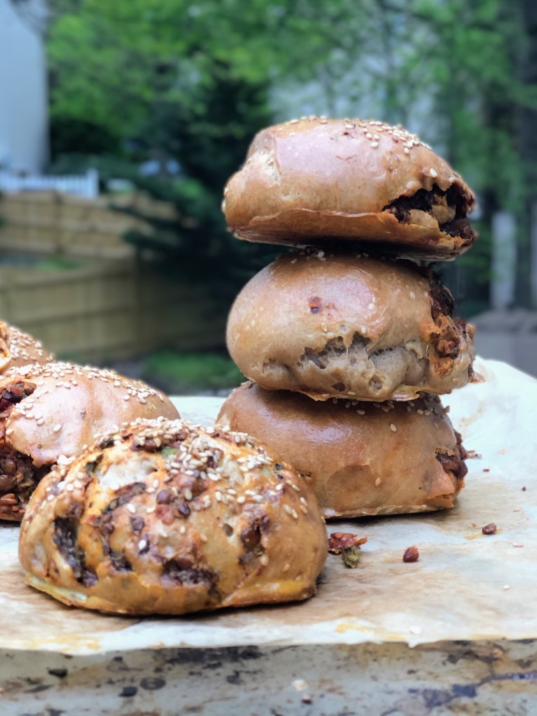 Spelt Buns stuffed with black lentils and caramelized onions, topped with sesame seeds.