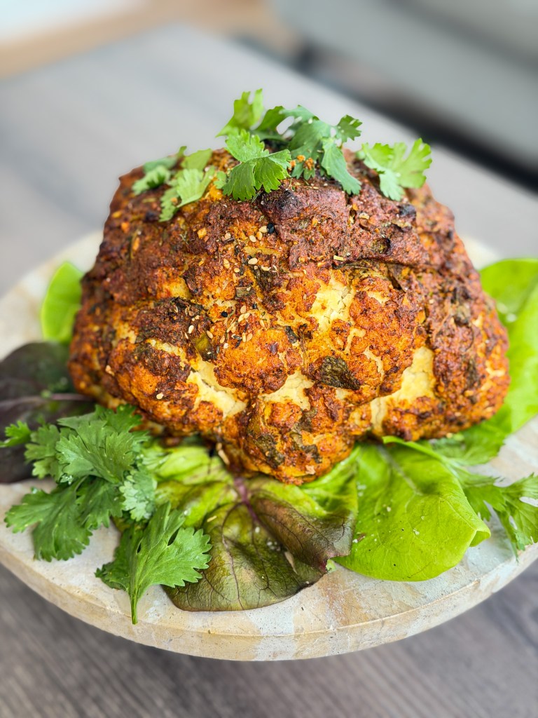 A whole cauliflower marinated in creamy spiced yogurt and roasted until golden, caramelized and tender
