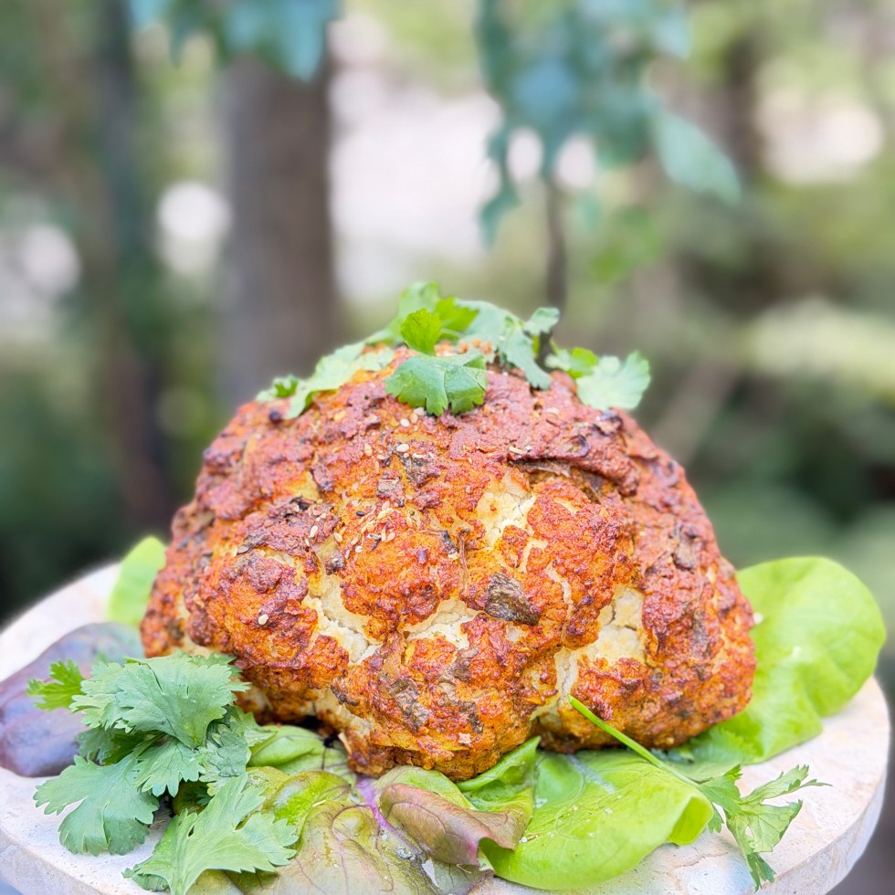A whole cauliflower marinated in creamy spiced yogurt and roasted until golden, caramelized and tender