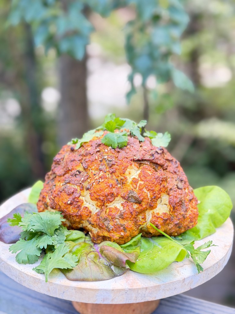 A whole cauliflower marinated in creamy spiced yogurt and roasted until golden, caramelized and tender