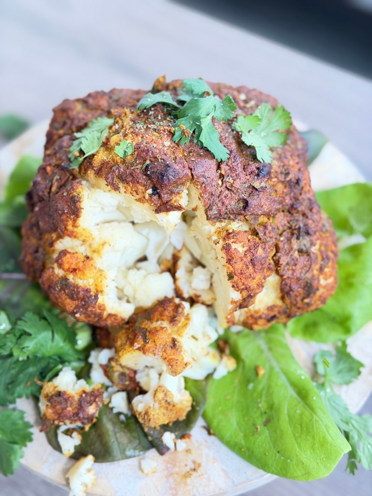 A whole cauliflower marinated in creamy spiced yogurt and roasted until golden, caramelized and tender